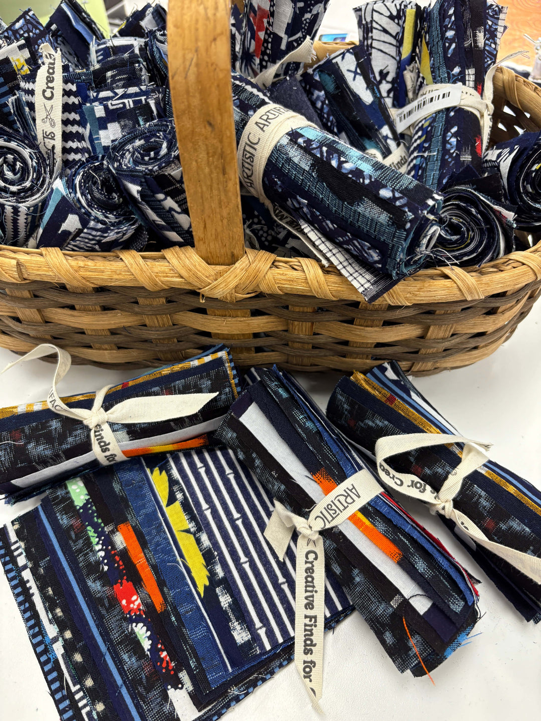 Basket of rolled fabric bundles.
