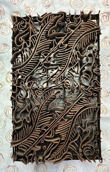 Decorative copper tjap with intricate leaf patterns 