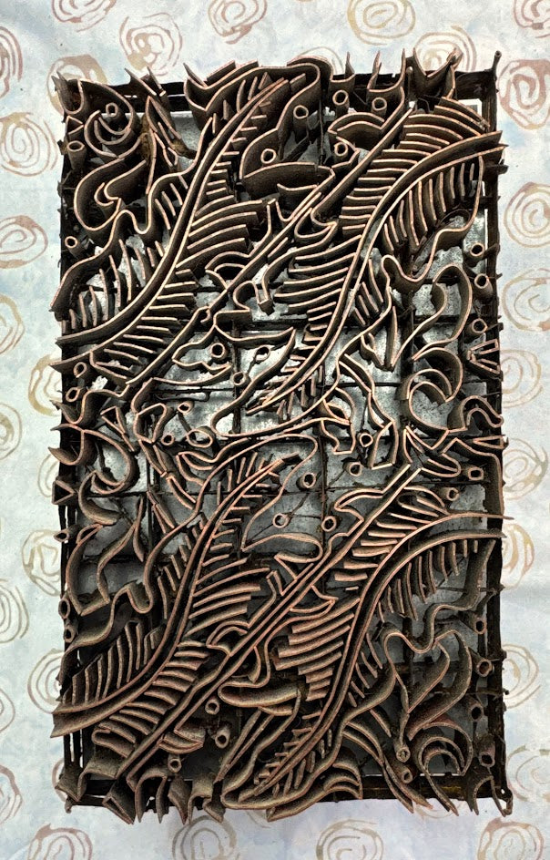 Decorative copper tjap with intricate leaf patterns 