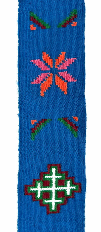 Blue woven fabric with colorful embroidered geometric patterns.