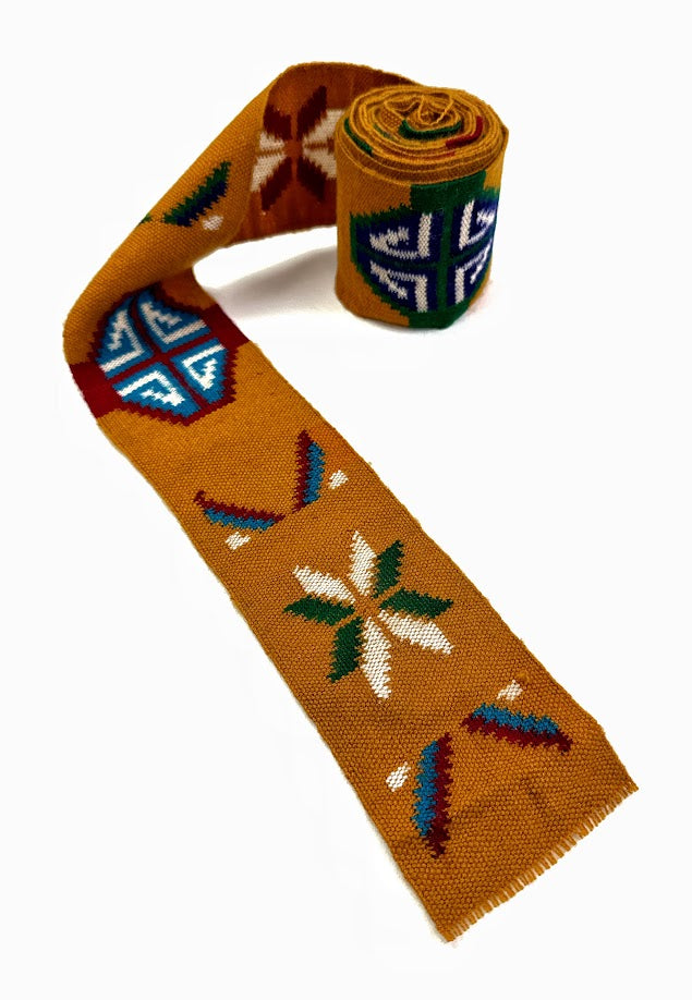 Mustard-colored woven belt with geometric patterns, rolled and unrolled.