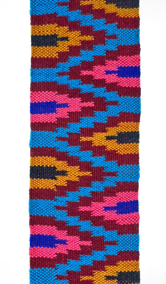 Woven textile with repeating geometric pattern in bright colors.