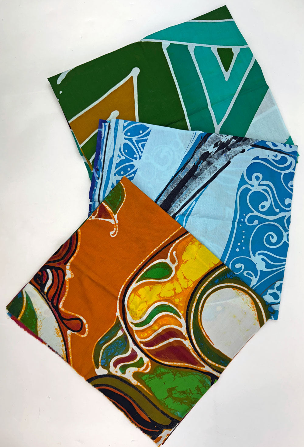 Four colorful patterned fabric squares.