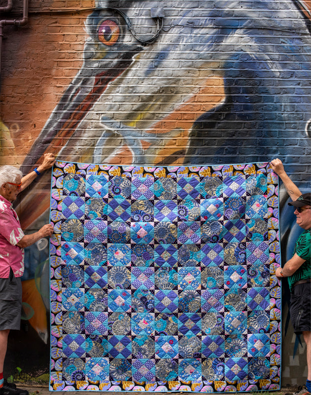 KF-QiL Quilt held in front of heron mural