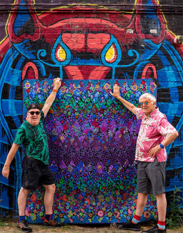 KF-QiL back cover art with two men in front of mural