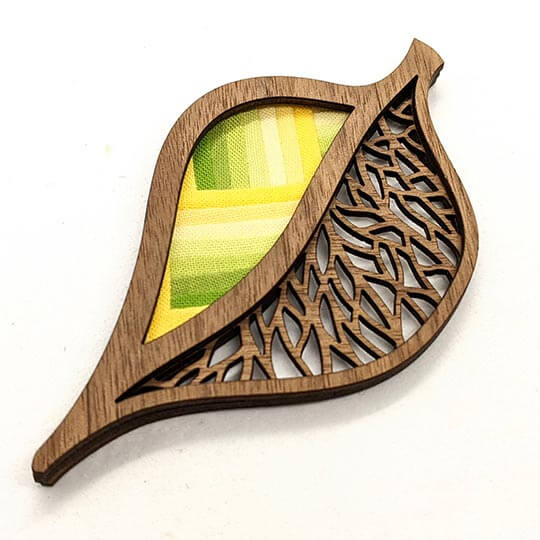 Leaf Brooch with intricate wood cutout and fabric backing.