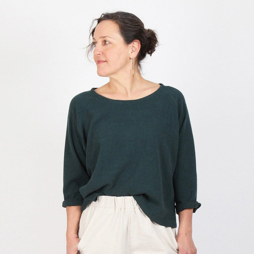 Woman in dark green raglan top