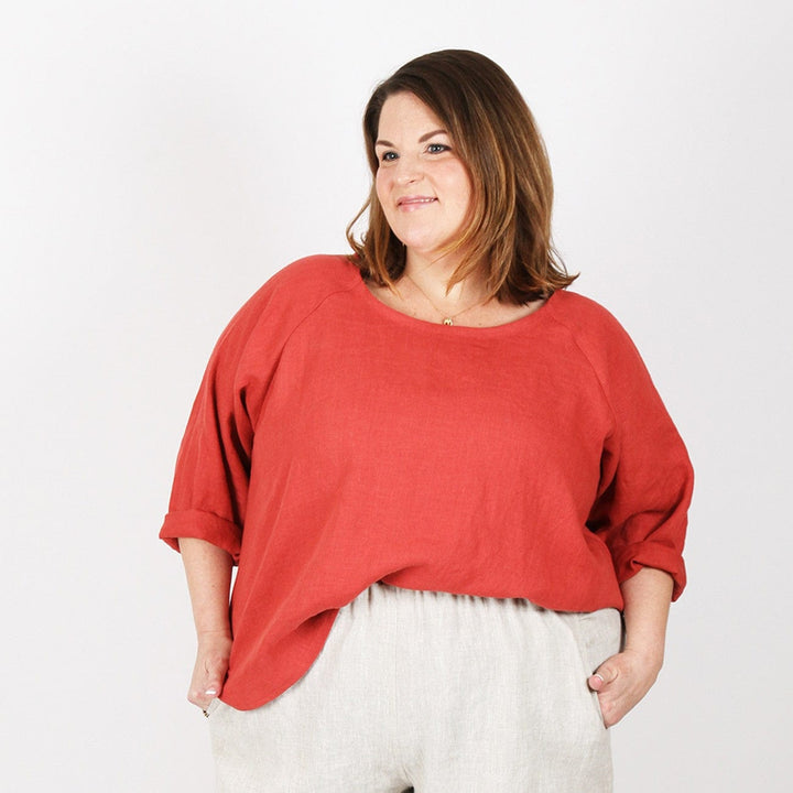 Woman in red top & beige pants