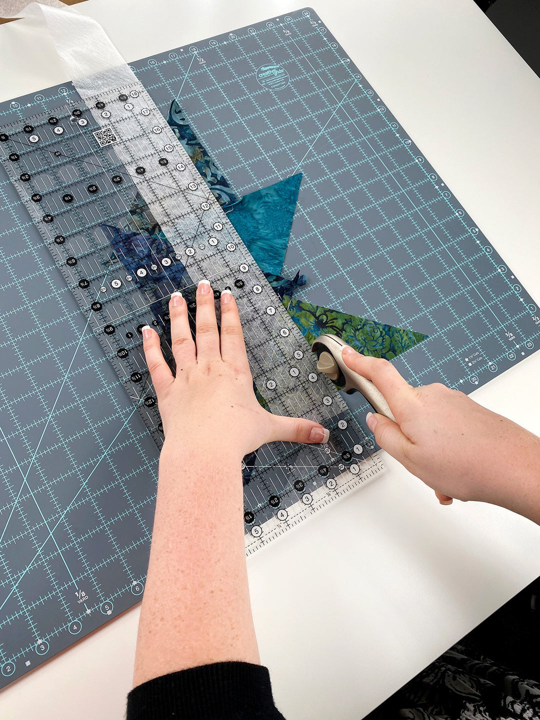 Quilting fabric being cut with a rotary cutter
