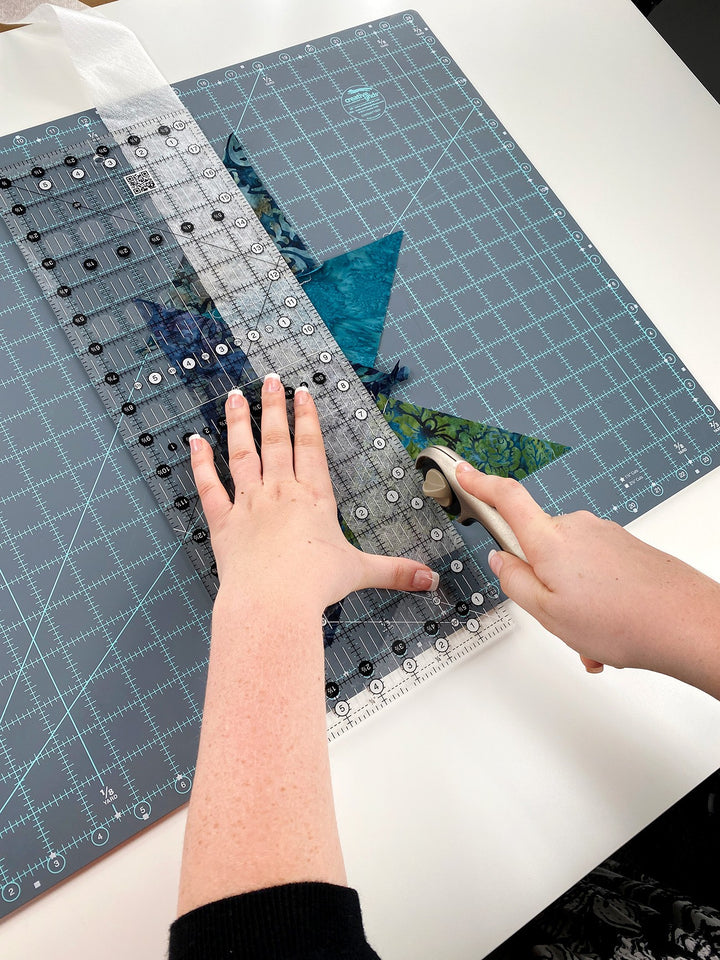 Quilting fabric being cut with a rotary cutter