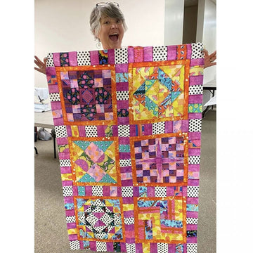 Woman holding colorful bright quilt display