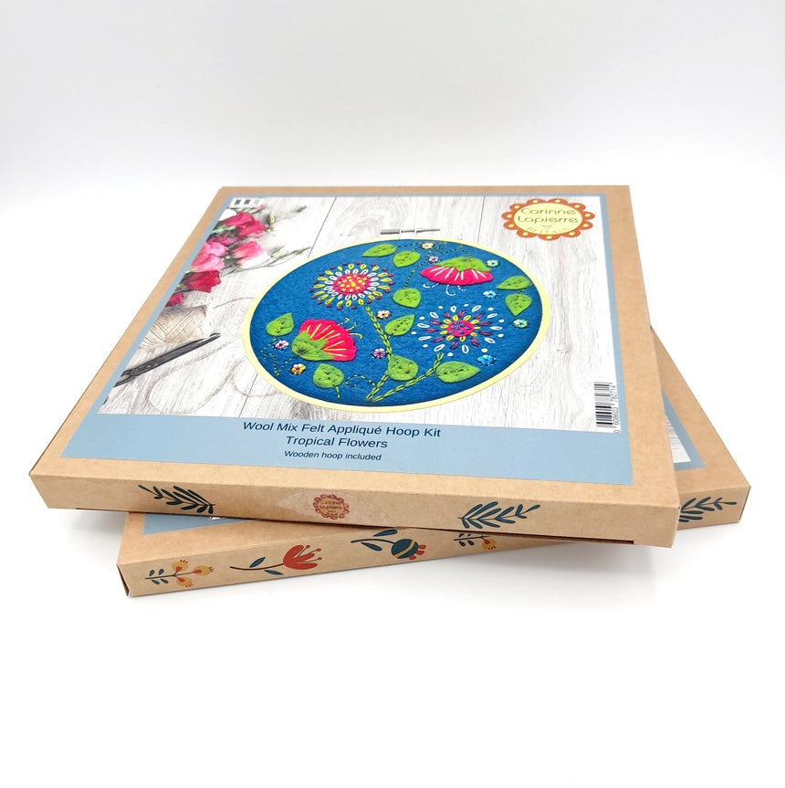 Two craft kits stacked, featuring tropical flower embroidery.