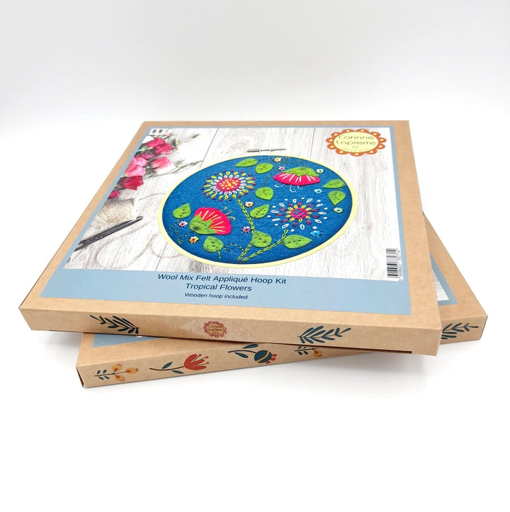 Two craft kits stacked, featuring tropical flower embroidery.