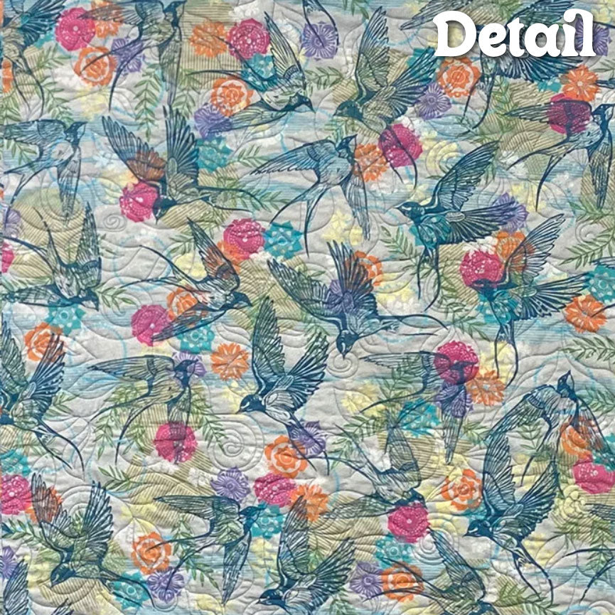 Finnepoly quilted detail with birds and floral pattern.