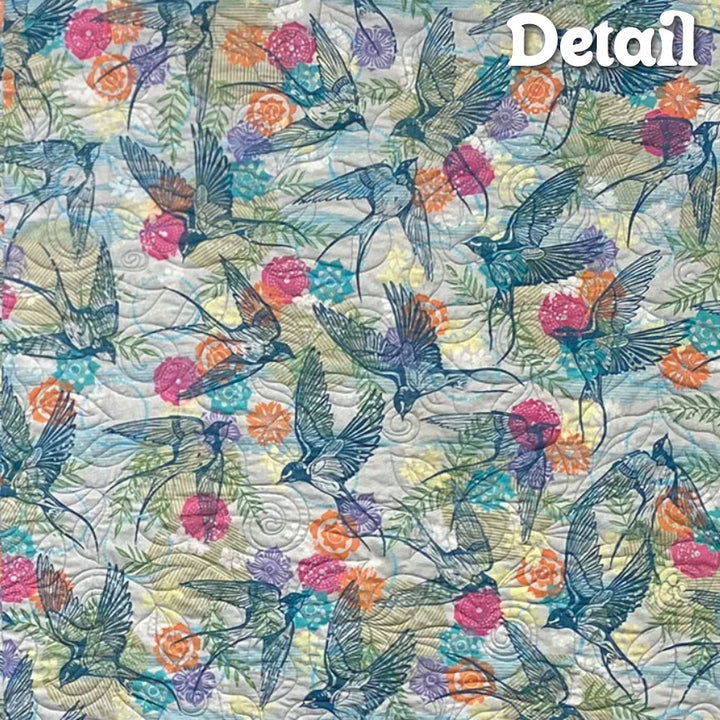 Finnepoly quilted detail with birds and floral pattern.