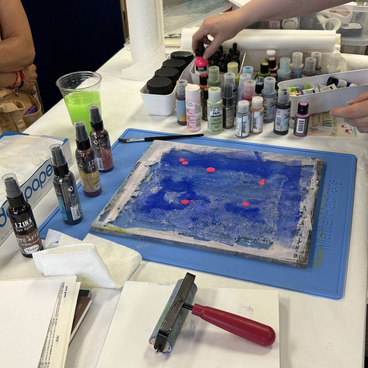 Gel printing in open studio with paint and supplies.